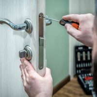Professional,Locksmith,Worker,Installing,The,Part,Of,Lock,In,Wooden